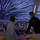 Two people facing away from the camera stare out a spaceship window as the stars appear to whiz past.